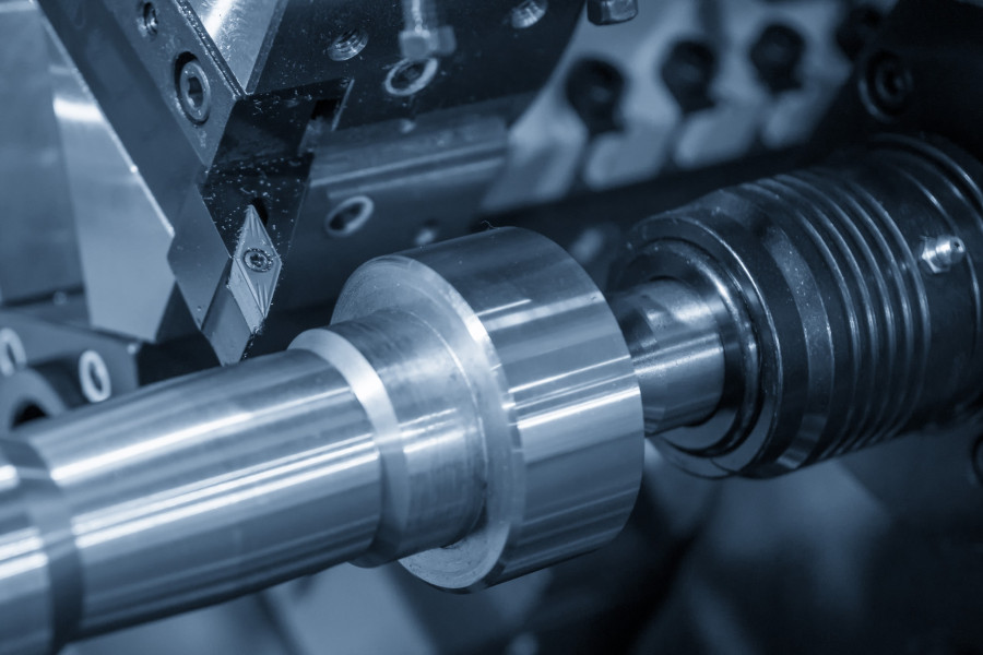 The lathe machine cutting the metal parts